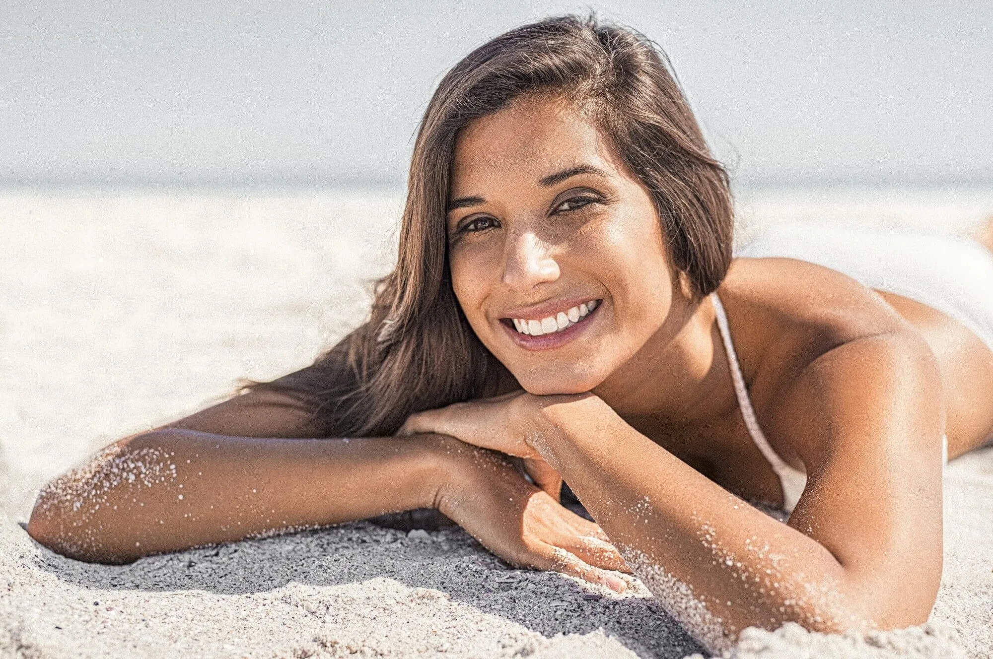 A young black women lying on beach