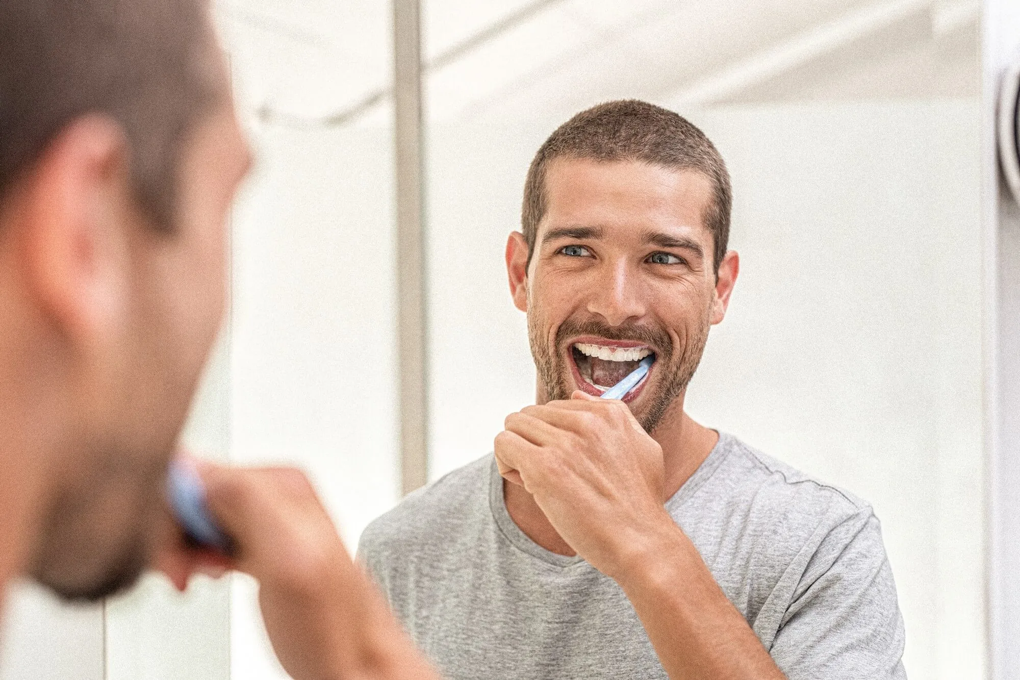 A boy is brushing his teeth