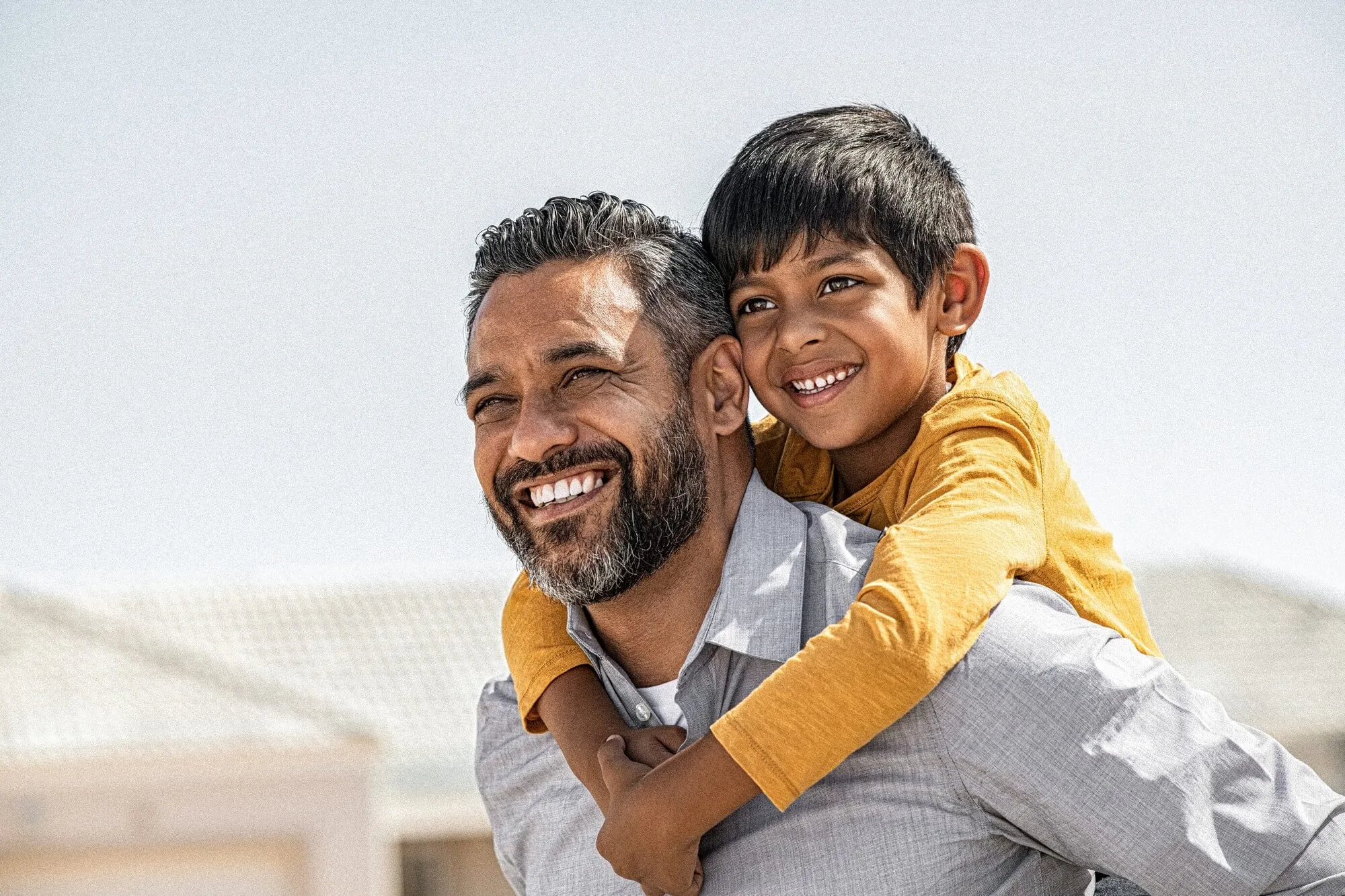 Father Holding Child at Back
